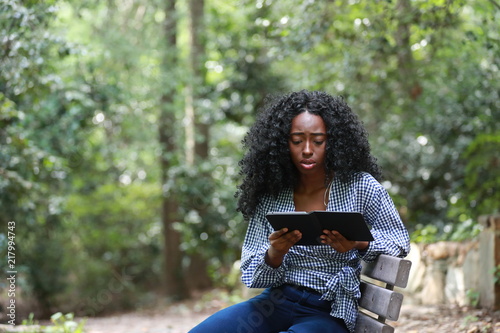 Upset black woman reading sorrowful book
