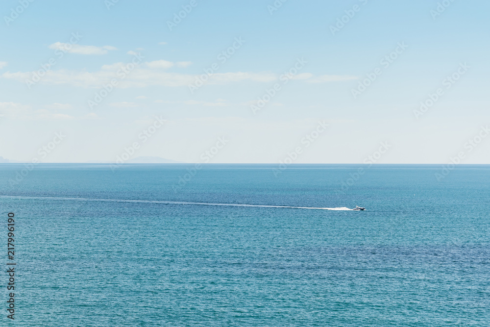 Boat rides in the open blue sea.