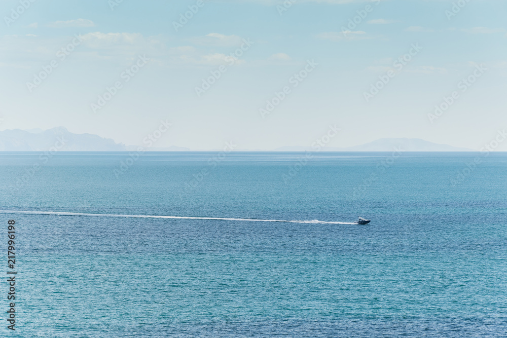 Boat rides in the open blue sea.
