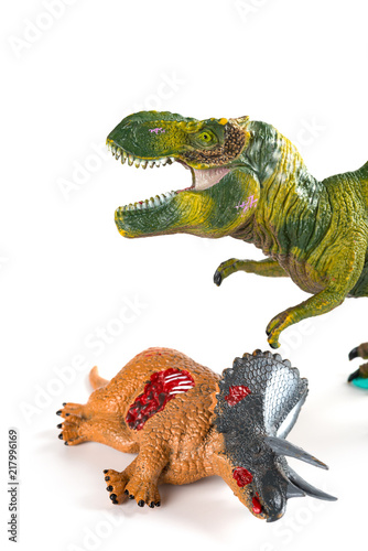 tyrannosaurus with a triceratops body nearby on white background vertical composition