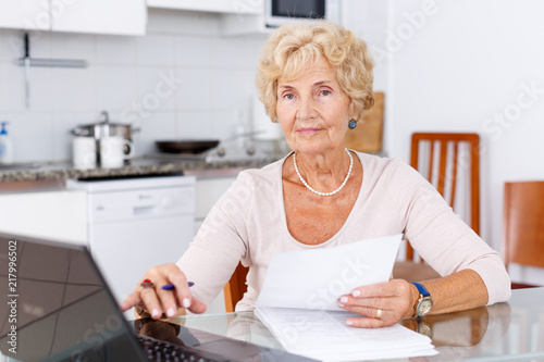 Mature woman filling up documents