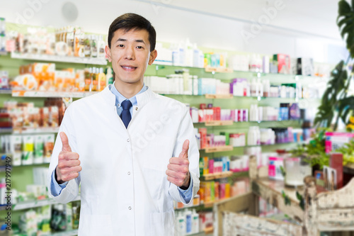japanese male specialist who is standing in pharmacy © JackF