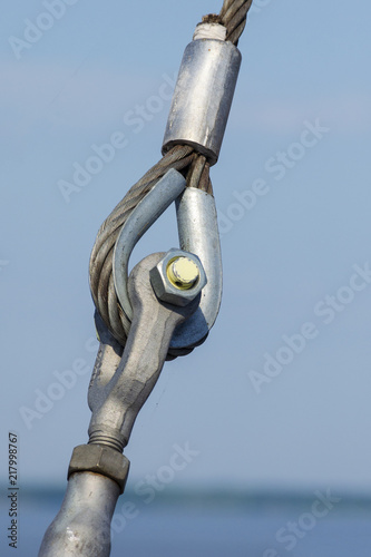 Loop connections of steel rope. Metal fastening element in ferry.