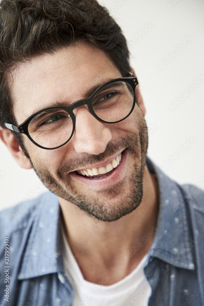 Smiling guy in glasses, looking away Smiling guy in glasses, looking away