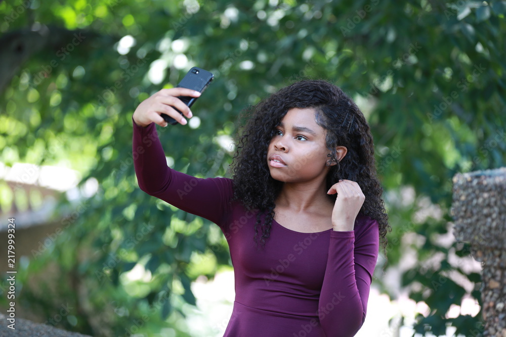 Charming black female taking selfie in park Charming black female taking selfie in park