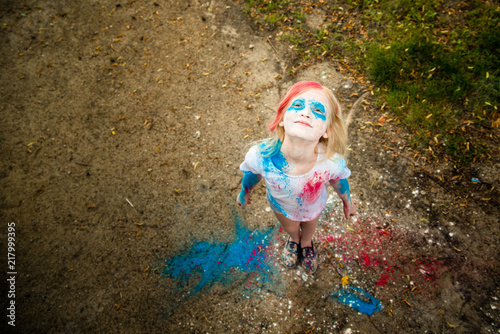 bright girl smiling, her face and hands in colors Holi  © Evgeny Sumin
