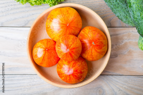 Red - yellow tomatoes on wooden background