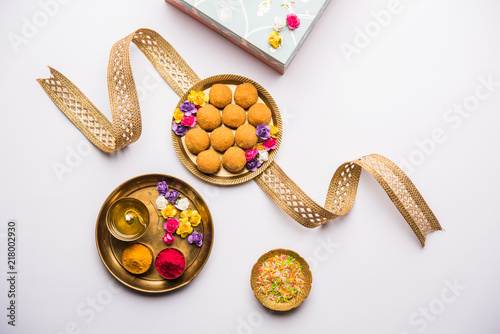 Fotografie Raksha bandhan Festival : conceptual Rakhi made using plate full of Bundi Laddu sweet with band and Pooja Thali