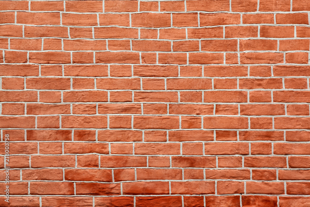 Naklejka premium Red brick wall of an building, background texture of a brick