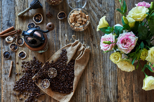 Coffee beans, brown sugar and antique accessories on wooden table.