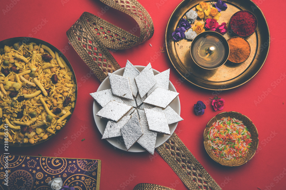 Raksha bandhan Festival greetings: conceptual Rakhi made using a plate full of Kaju Katli Barfi/Burfi and fancy band and pooja Thali. selective focus Raksha bandhan Festival greetings: conceptual Rakhi made using a plate full of Kaju Katli Barfi/Burfi and fancy band and pooja Thali. selective focus