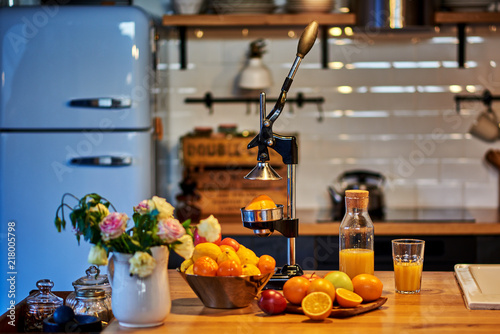 Orange juice freshly squeezed from fresh fruits with a juicer.. © eskstock