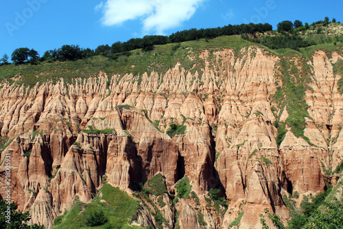 Scenic view with the Red Ravine, a unique natural monument with impressive craggy reddish badlands relief near Sebes city, Alba county, Romania.