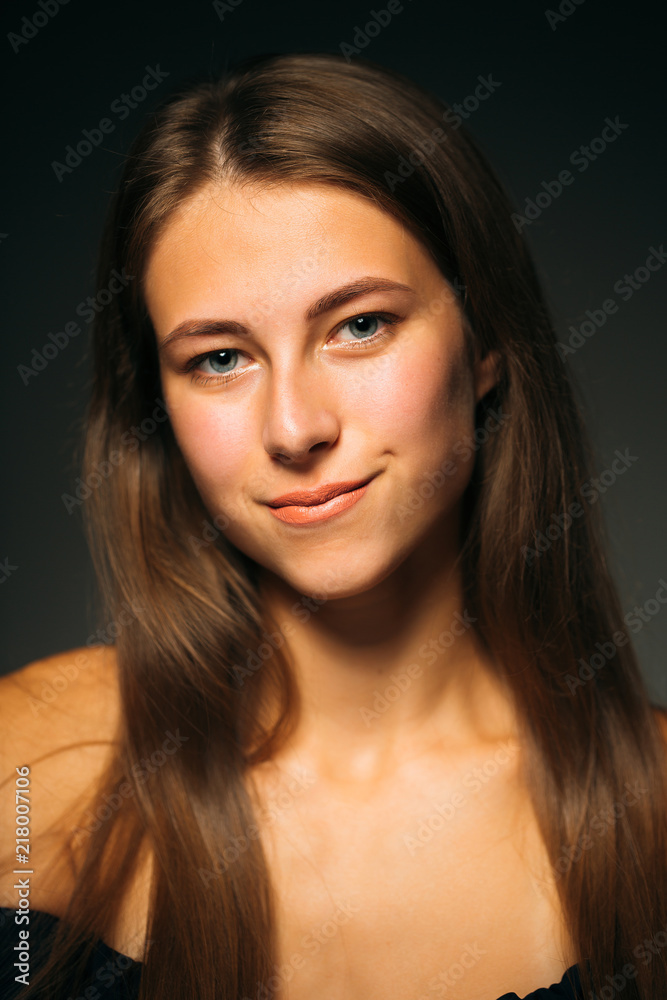 Portrait beautiful girl on a dark studio background Portrait beautiful girl on a dark studio background