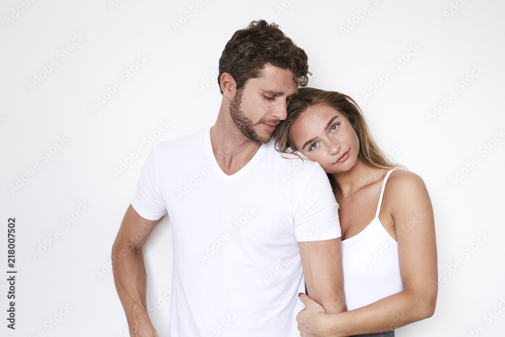 Loving couple in white clothing and studio, portrait Loving couple in white clothing and studio, portrait