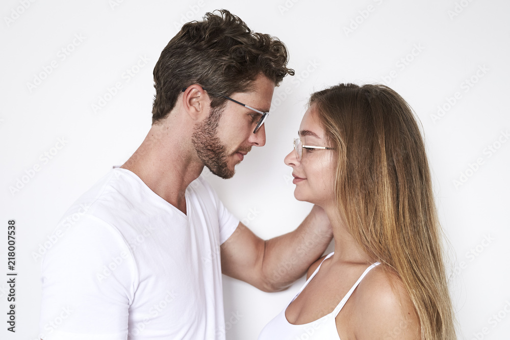 Face to face young couple in white studio