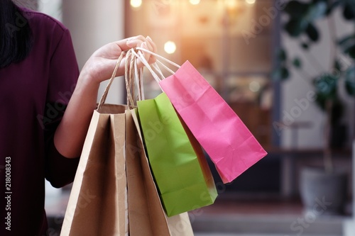 Fotografija Asian girls holding sale shopping bags