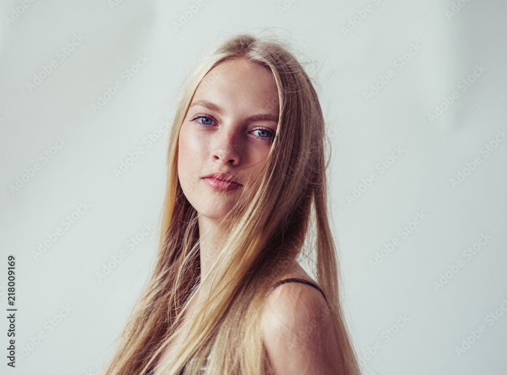 Blonde long hair woman girl in silver dress over white background Blonde long hair woman girl in silver dress over white background