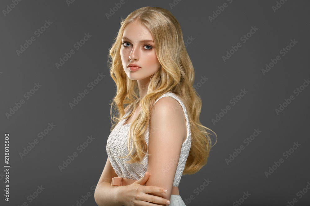 Beautiful woman with long blonde hair over gray background beauty female Beautiful woman with long blonde hair over gray background beauty female