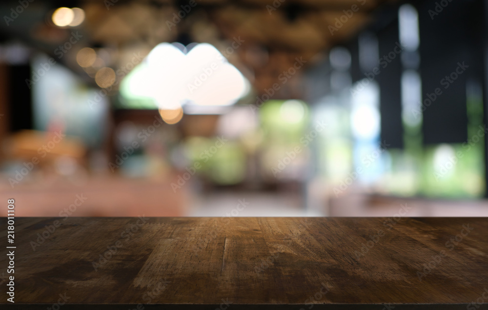 Empty dark wooden table in front of abstract blurred bokeh background of restaurant . can be used for display or montage your products.Mock up for space. Empty dark wooden table in front of abstract blurred bokeh background of restaurant . can be used for display or montage your products.Mock up for space.