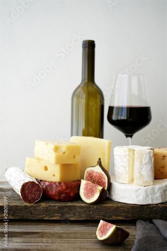 Set of cheeses and salami on rustic wooden table. Snacks for wine
