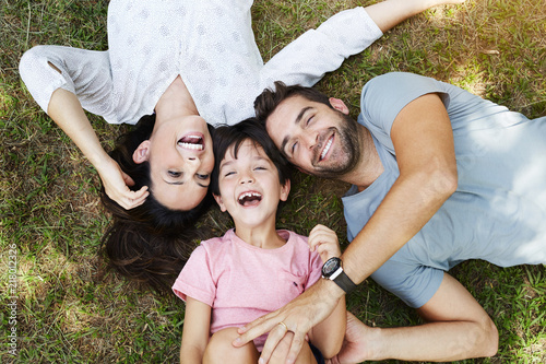 Family smiling together in park