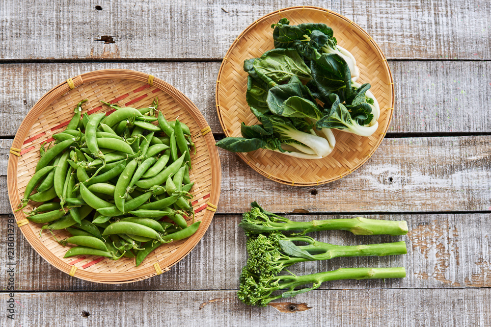 Green peas, Broccoli ,Chinese cabbage on wicker plates. Green peas, Broccoli ,Chinese cabbage on wicker plates.
