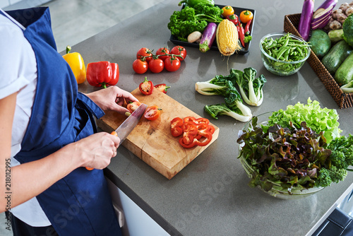 Chef cutting fresh and delicious vegetables for cooking. photo