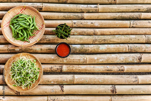 Asian food ingredients on the background of bamboo table. Top view. Copy space.
