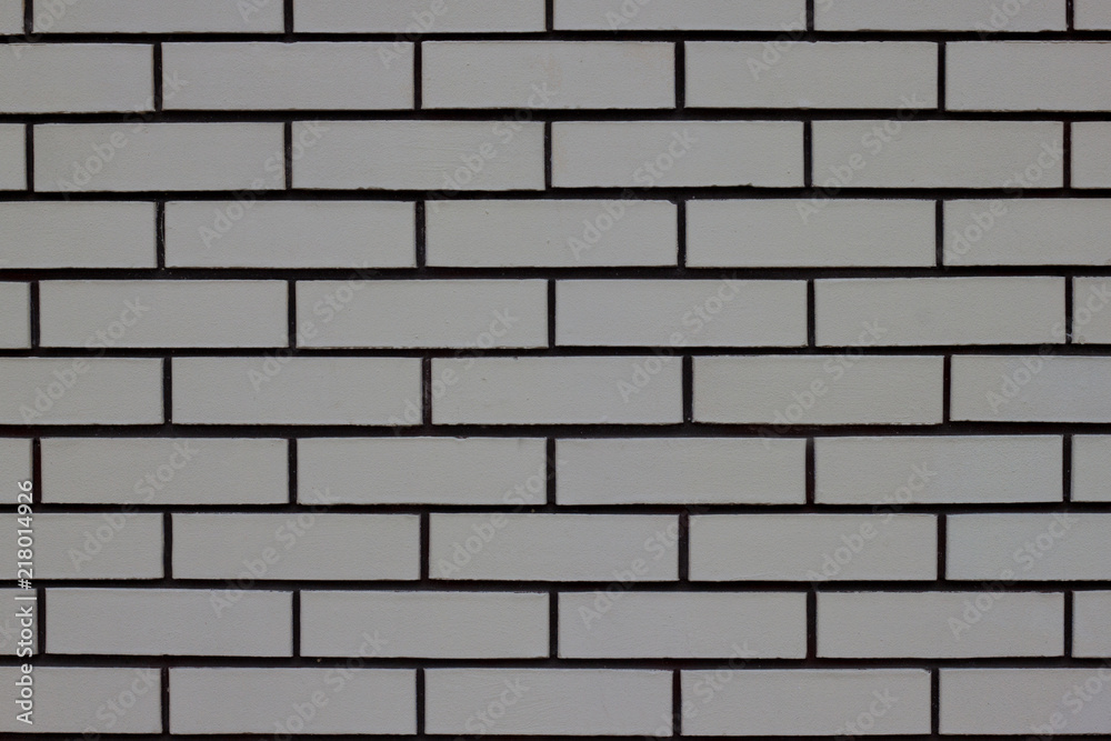 Fragment of gray brick house wall. Copy space for your text. - obrazy, fototapety, plakaty 