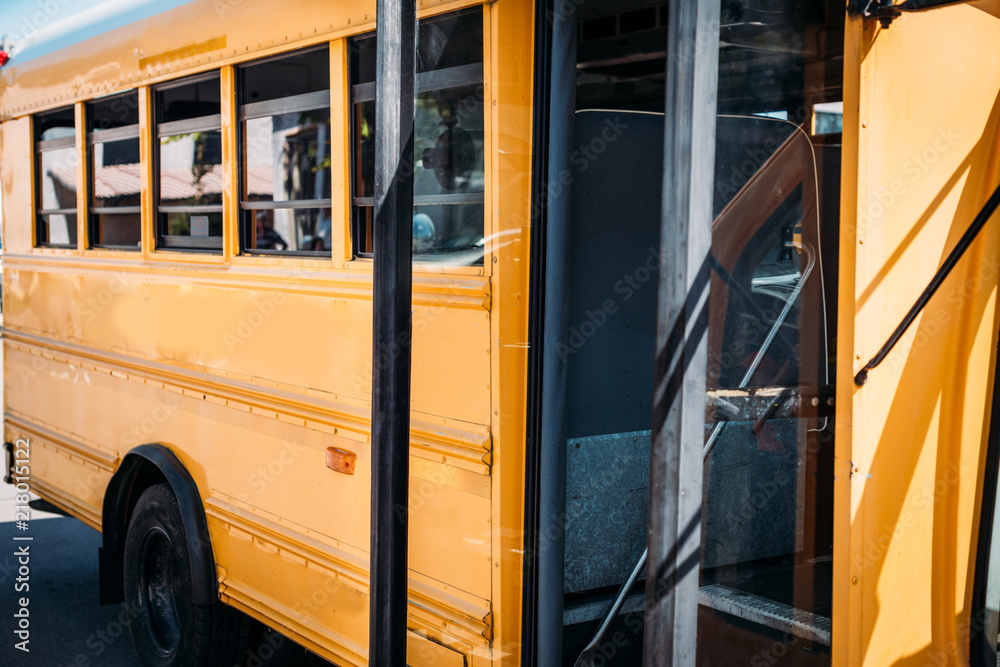 partial view of opened empty school bus parked on street