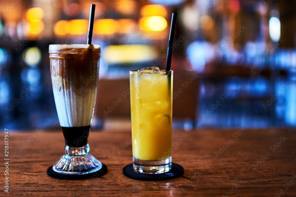 Glasses with orange juice and coffee frappe. Glasses with orange juice and coffee frappe.