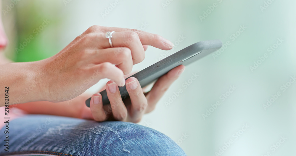 Close up Woman using mobile phone inside shopping plaza