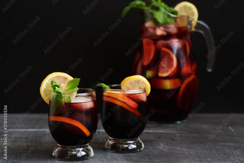 A carafe and glasses of sangria, a typical Spanish alcoholic drink. Red  cold sangria with lemon and ice on dark background.Selective focus. Stock  Photo | Adobe Stock