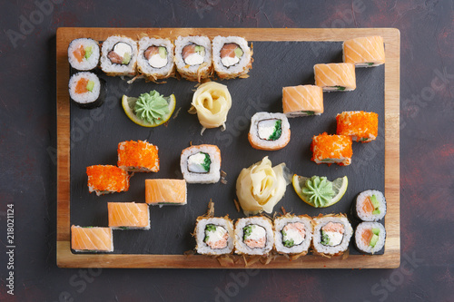 Big set of rolls served on stone plate. Top view.