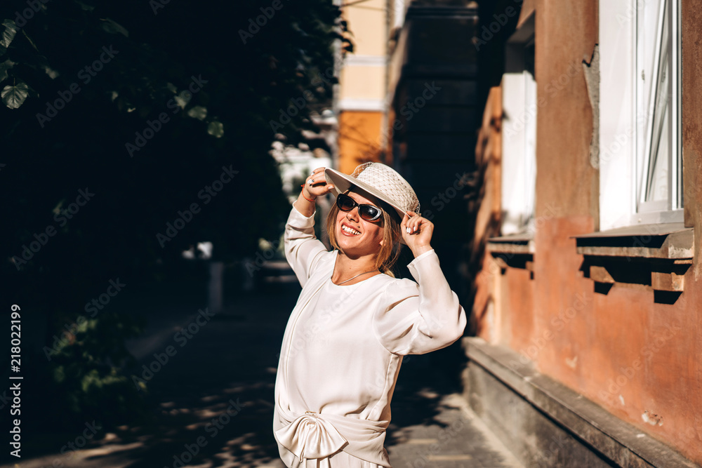 Woman in white vintage dress walking on the street