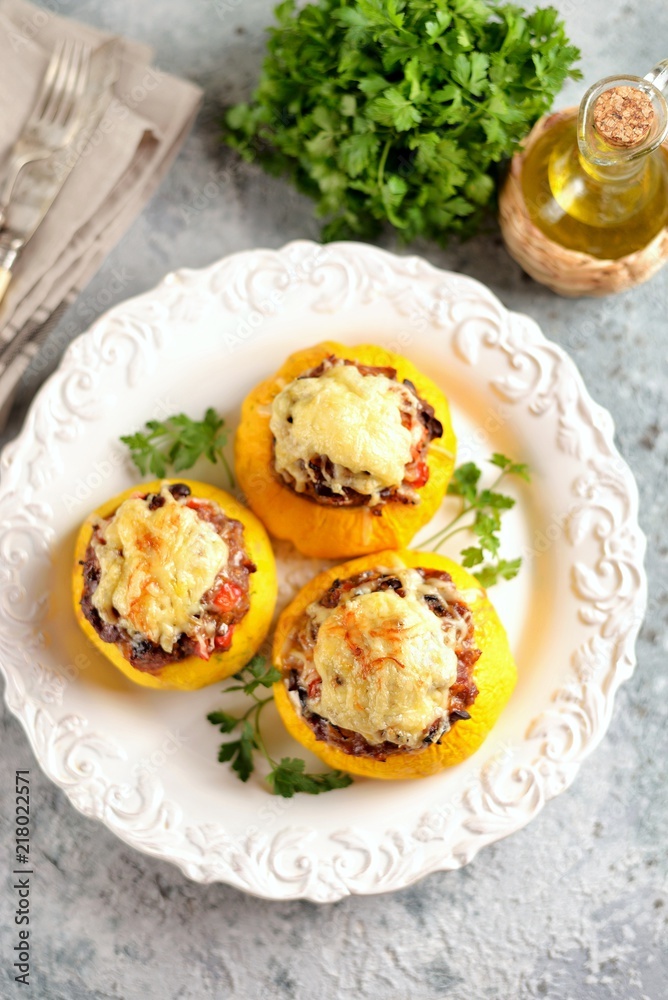 Organic yellow patissons stuffed with meat, onions, carrots, mushrooms and red pepper baked in the oven with cheese.