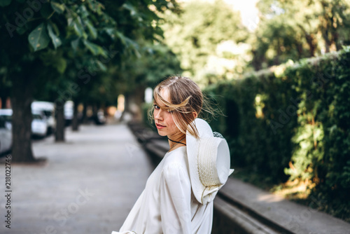 Woman in vintage white dress walking outdoor © bedya