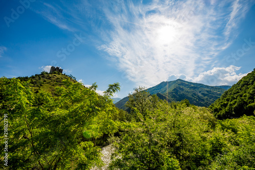 Ruins of the old fortress on a mountain hill in Serbia  green springtime landscape with spectacular clouds