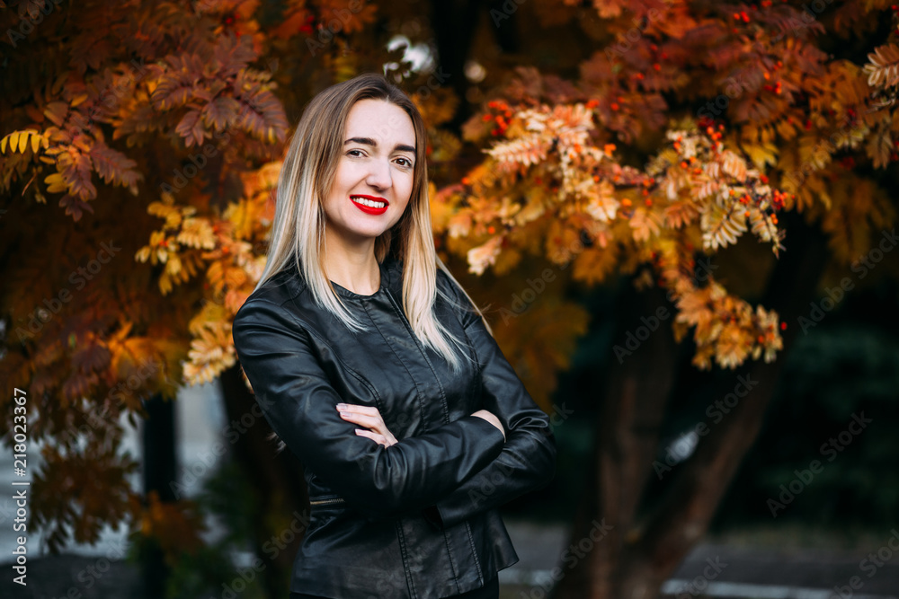 young woman in leather jacket on autumn background young woman in leather jacket on autumn background