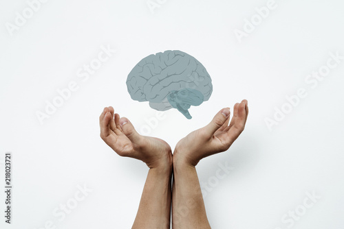 Hands arranged in a gesture of support. Two hands stacked side by side include the brain. Medical concept, brain tumor. Help others, support in brain problems, alzhaimer. photo