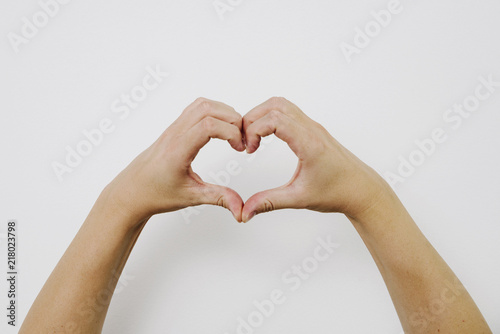 Heart made of hands. Concept of love  respect and support. Hands are laying on a heart sign on a bright white background. Search for support and love.