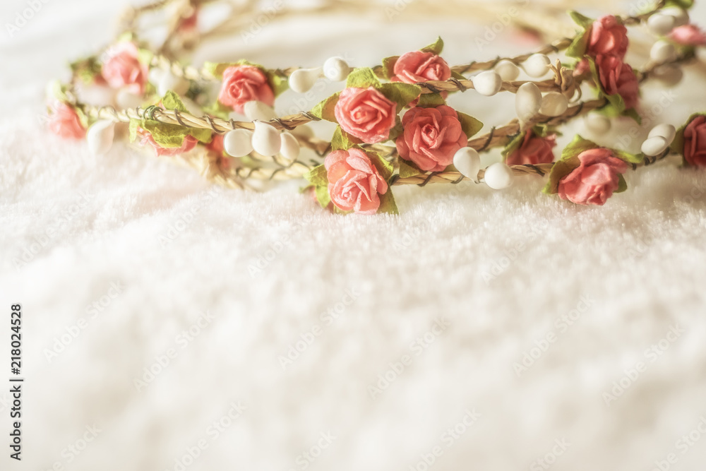 soft focus handmade floral tiara made of rose flowers on white fur background with copy space. hand crafted decorative fashion accessories. artificial flowers crown. soft focus handmade floral tiara made of rose flowers on white fur background with copy space. hand crafted decorative fashion accessories. artificial flowers crown.