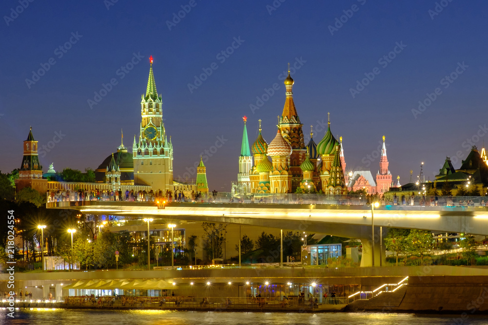 City landscape with night view on soaring bridge in Zaryadye and Red Square in Moscow.