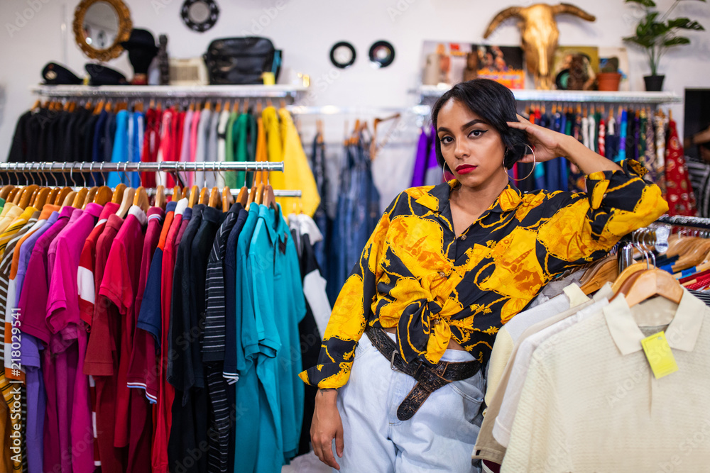 Stylish woman leaning on rack in shop Stylish woman leaning on rack in shop