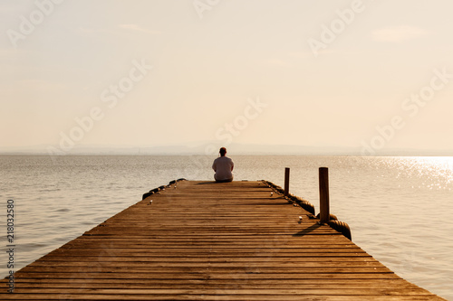 Girl in a harbor at sunset