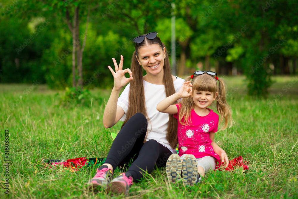 Mother and little daughter playing together in park. Outdoor Portrait of happy family. Happy Mother's Day Joy. Mom and Baby Mother and little daughter playing together in park. Outdoor Portrait of happy family. Happy Mother's Day Joy. Mom and Baby