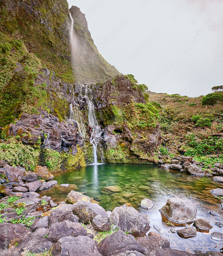 Fototapeta premium Panoramic view of pond and waterfall Poco do Bacalhau at the Azores island of Flores