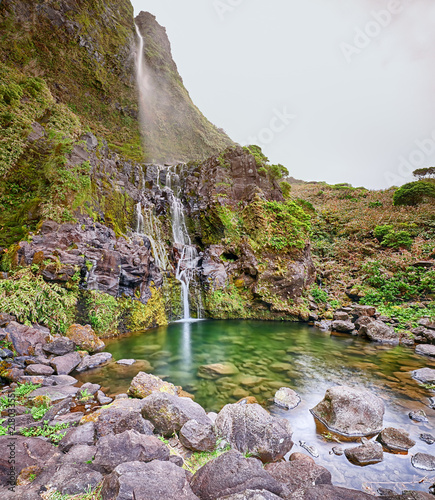 Fototapeta Naklejka Na Ścianę i Meble -  Panoramic view of pond and waterfall Poco do Bacalhau at the Azores island of Flores