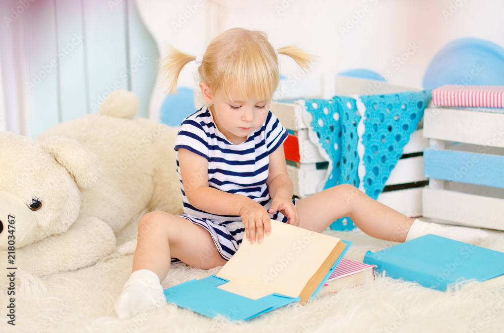 blond girl sitting on the floor with books blond girl sitting on the floor with books